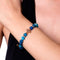 St. Lily of the Mohawks | Rose Gold Cross | Blue Striped Agate Bracelet